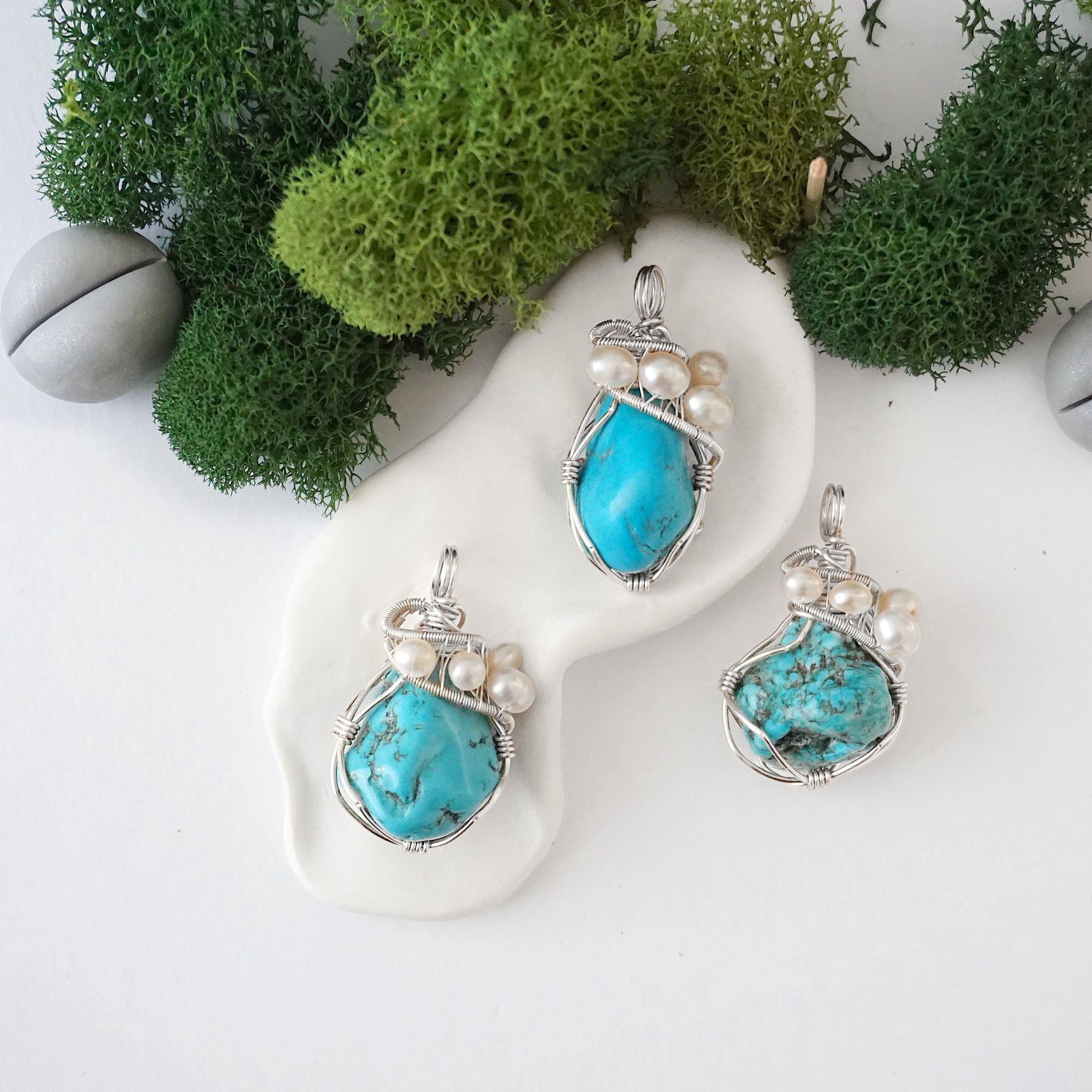 Three silver wire wrapped turquoise and freshwater pearl pendants showing natural stone variation, artisan jewelry for women