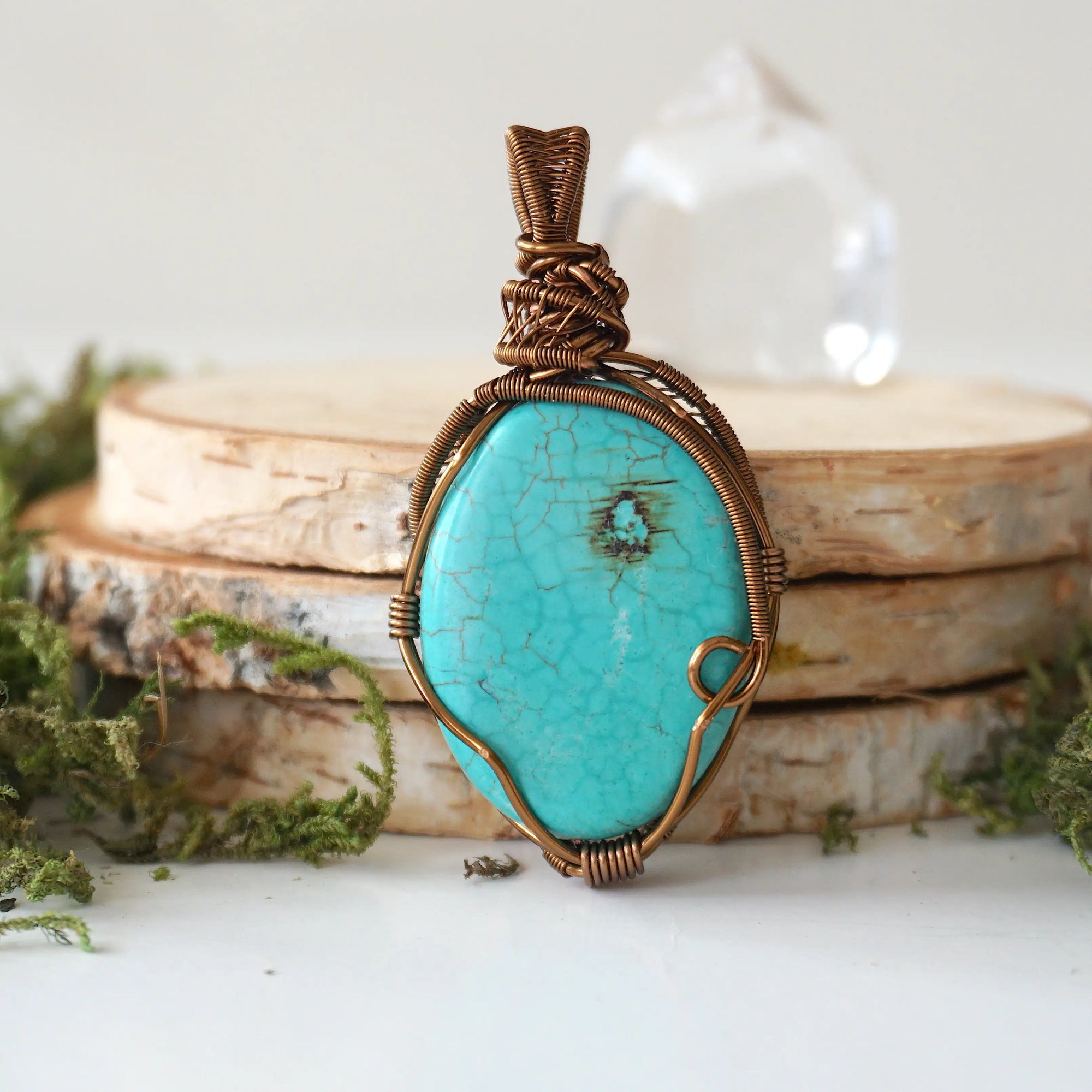 Back view of natural turquoise pendant revealing intricate wire work and artisan craftsmanship in antique bronze copper wire