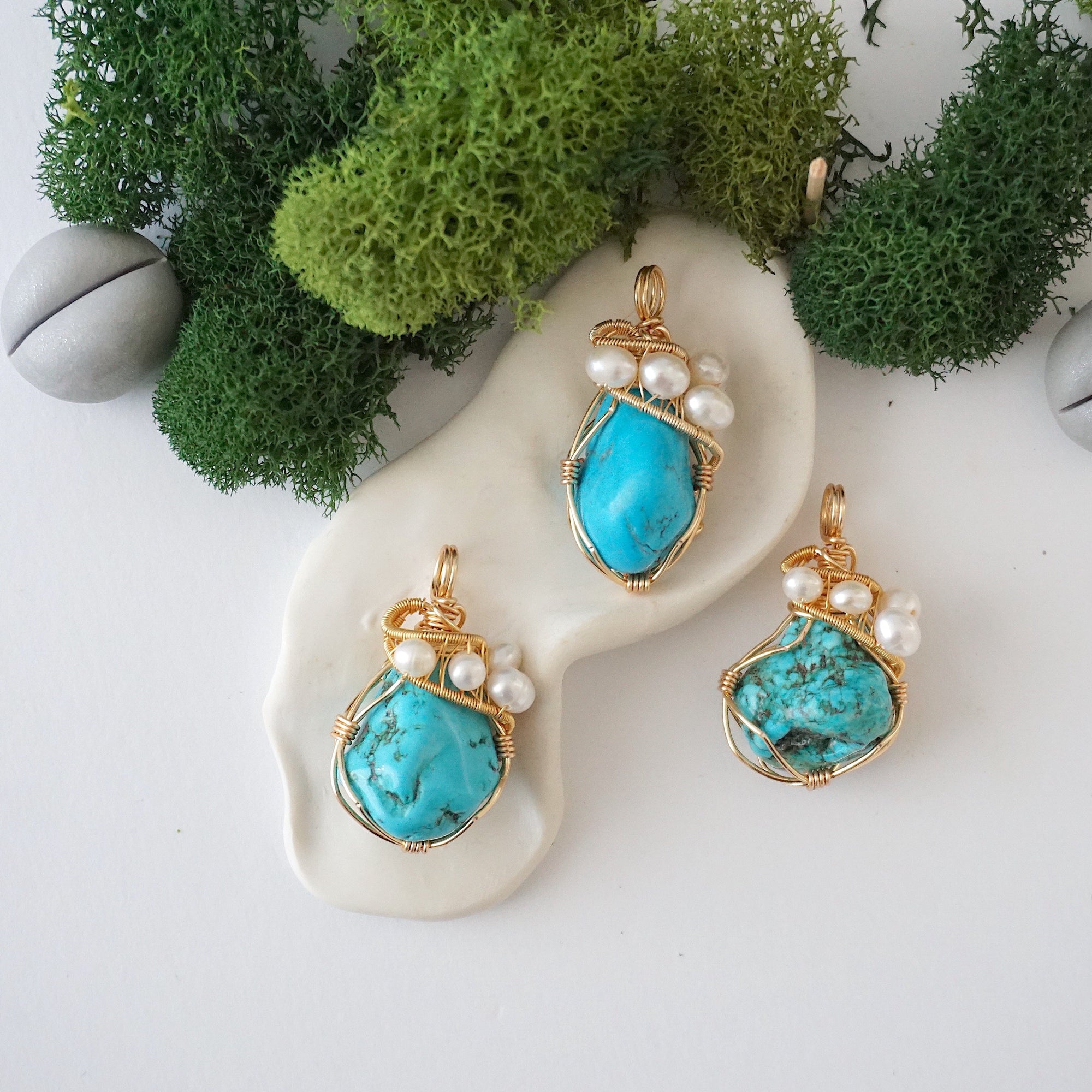 Three turquoise and pearl necklaces showing natural stone color variation and unique handmade designs