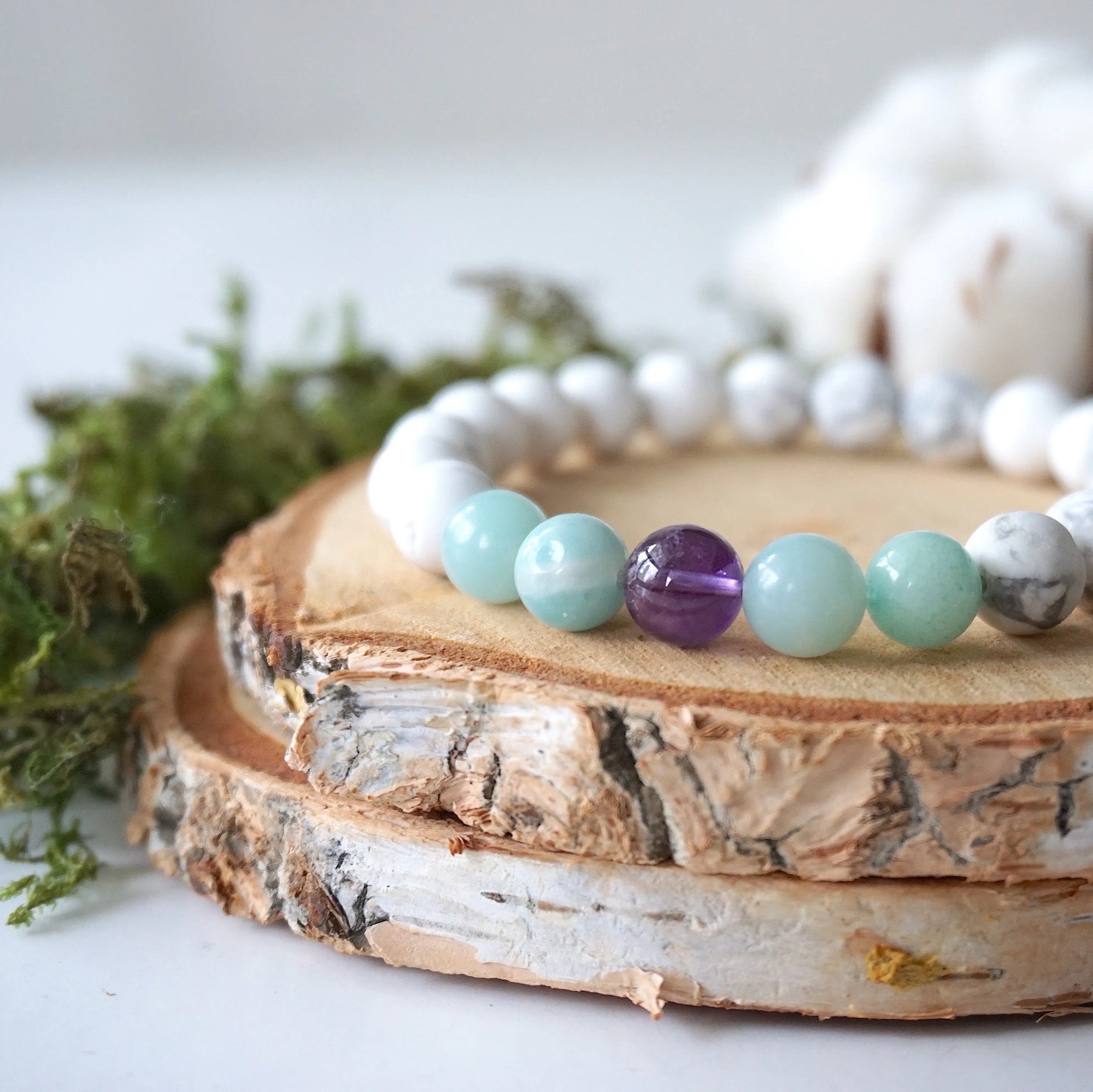 Close up side angle of white howlite, amethyst, and amazonite stretch bracelet, 8mm gemstone beads, calming jewelry