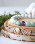 Close up side angle of white howlite, amethyst, and amazonite stretch bracelet, 8mm gemstone beads, calming jewelry