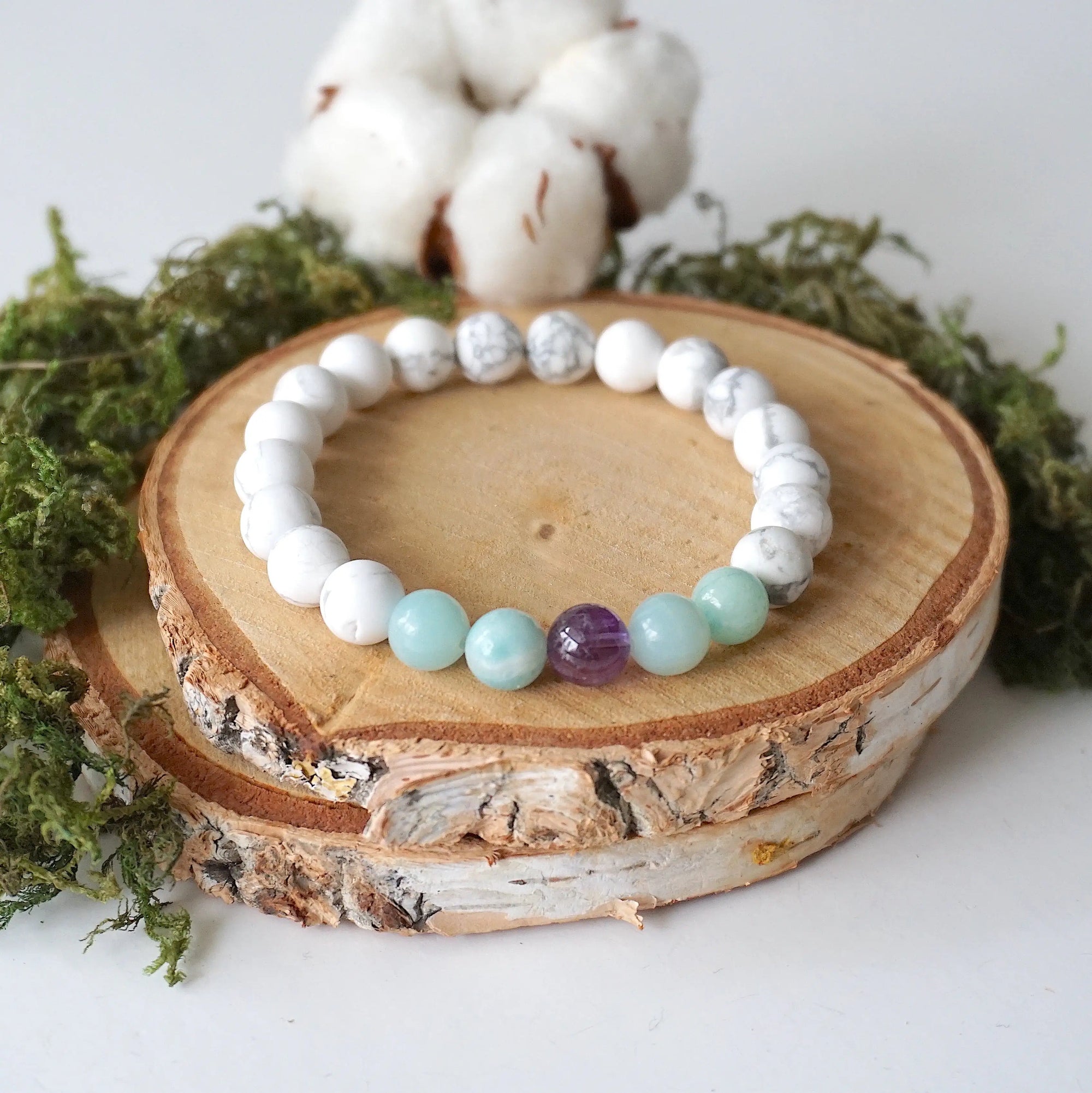 Full angled view of white howlite, amethyst, and amazonite stretch bracelet, natural gemstone beaded jewelry