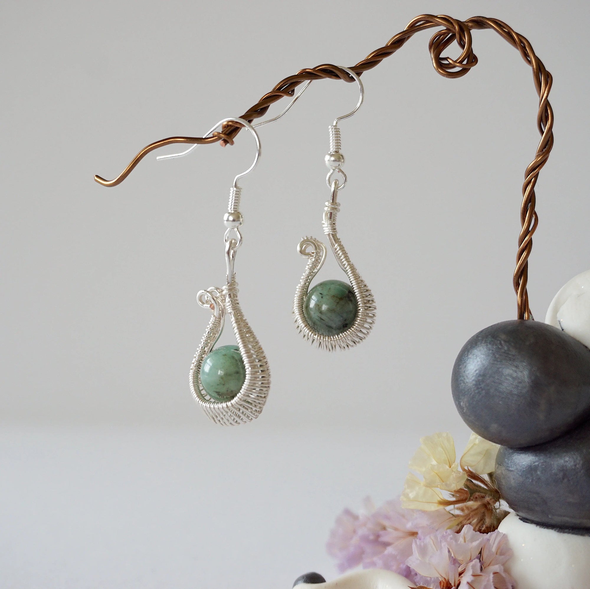 Wire wrapped emerald drop earrings in soft silver copper with natural emerald beads and handcrafted artisan design