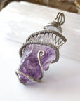 Left side angle of women’s raw amethyst pendant necklace wire wrapped in white gold plated copper