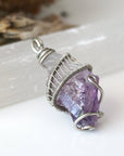 Right side angle of women’s raw amethyst pendant necklace wire wrapped in white gold plated copper