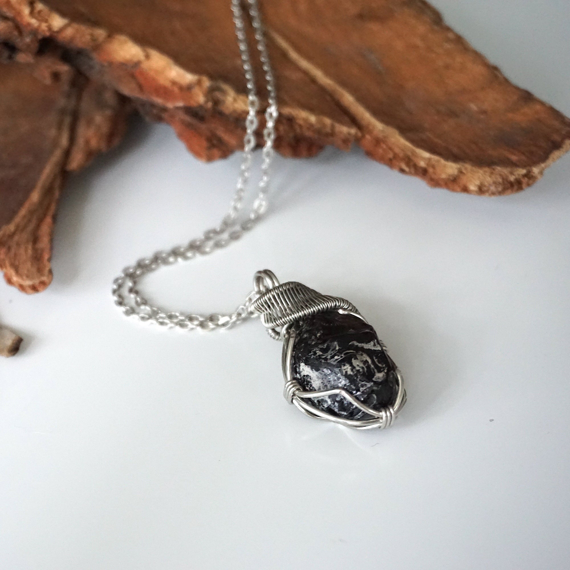 Handcrafted apache tears obsidian necklace on chain, laying flat – artisan white gold copper wire wrapping, natural volcanic glass, for all genders, Designs by Nature Gems.