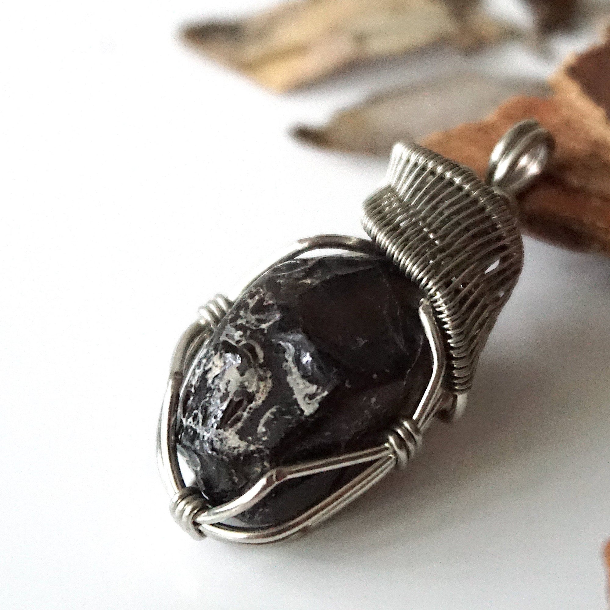 Left angle close-up of apache tears obsidian pendant – artisan wire wrapping, natural black stone, Designs by Nature Gems.