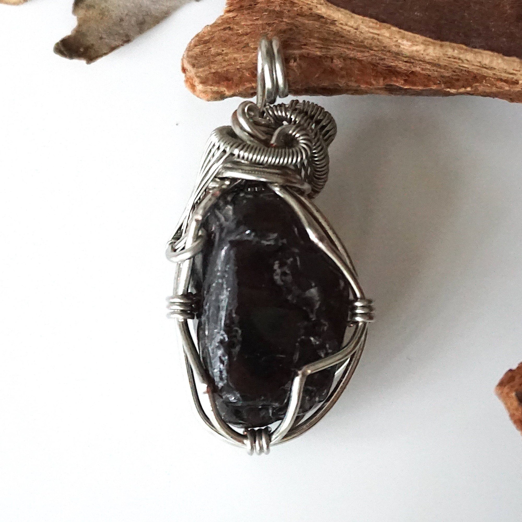 Back view of handcrafted apache tears obsidian pendant – natural volcanic glass and wire wrapping detail, Designs by Nature Gems.