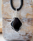 Handcrafted raw black onyx necklace for men, front view – artisan silver copper wire wrapping, July birthstone, flat black leather cord.