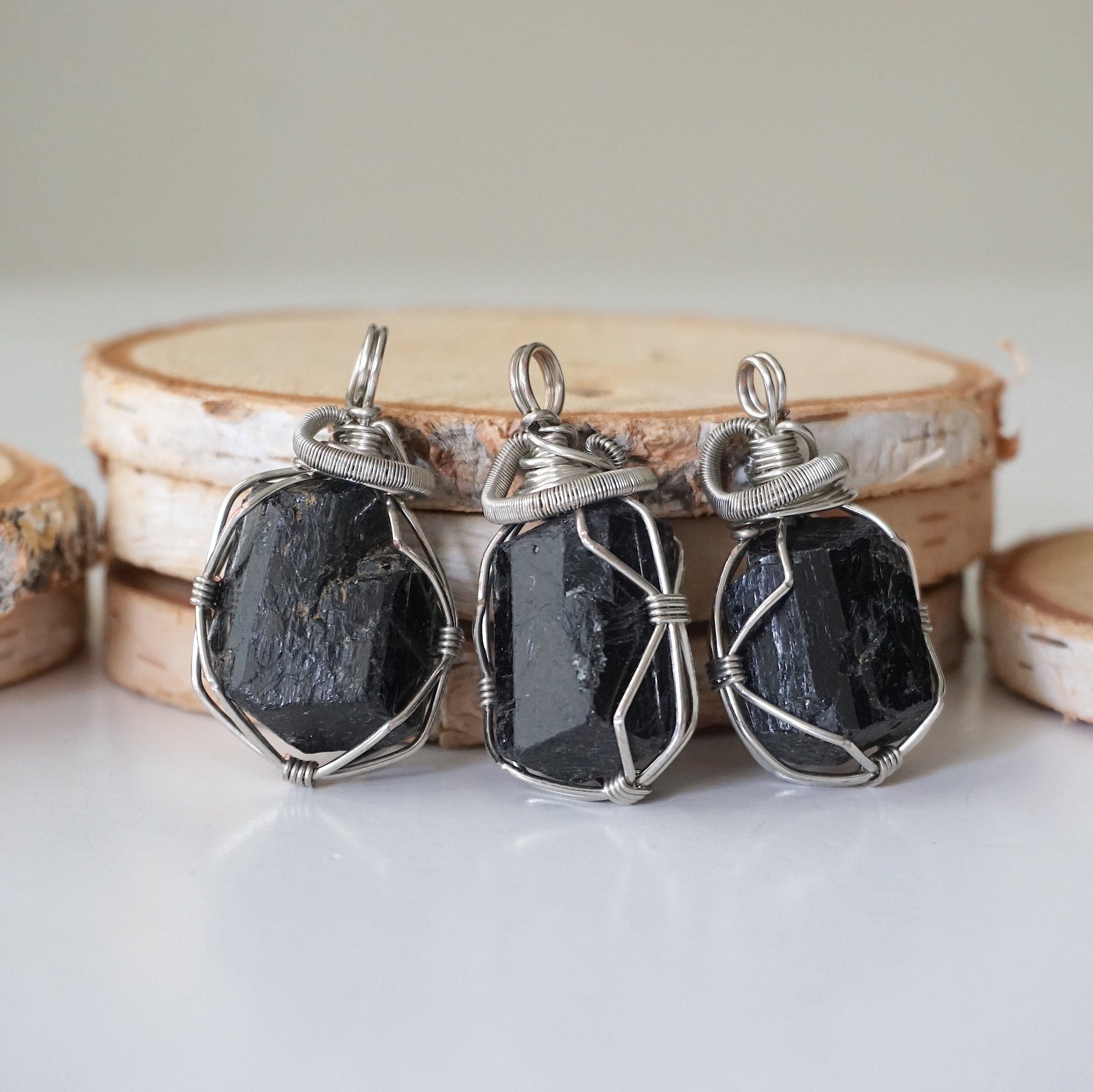 Three raw black tourmaline necklaces for men – shows natural variation in size, shape, and black color of tourmaline stones.