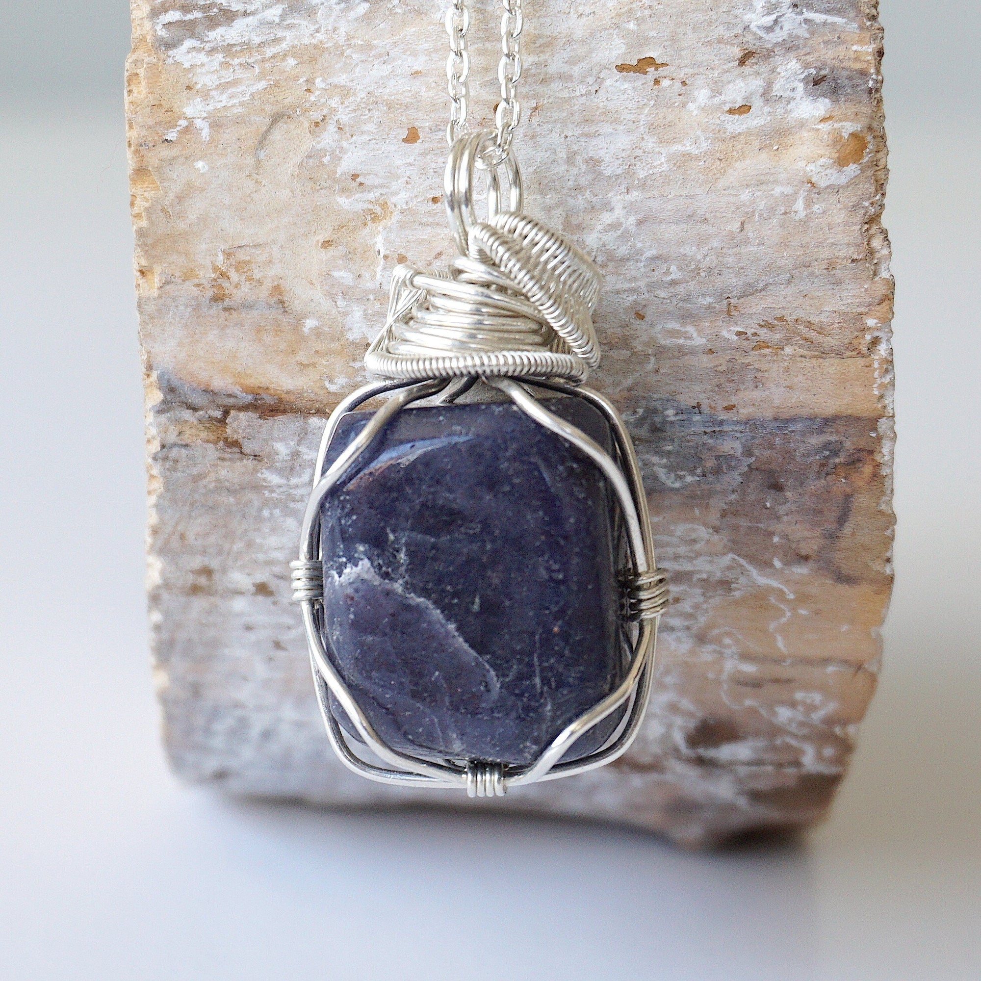 Back view of handcrafted sapphire necklace for men – natural stone and wire wrapping, September birthstone, 925 sterling silver.