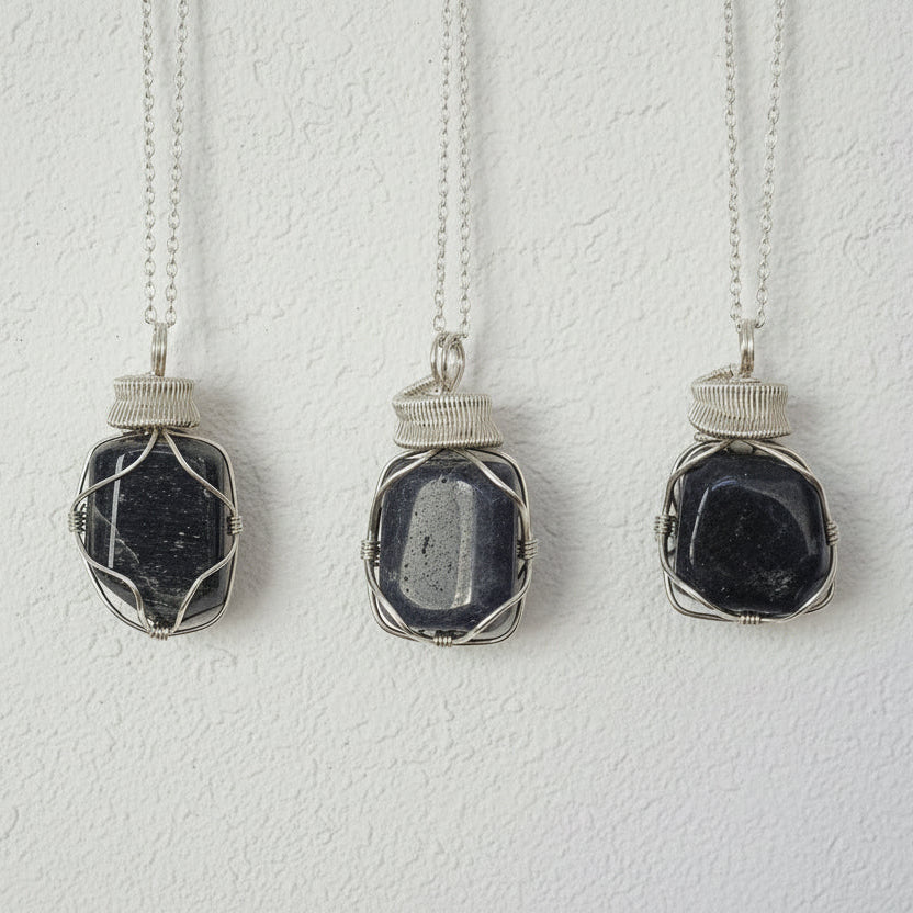 Three sapphire necklaces for men – showing natural variation in size, shape, and shade of blue, 925 sterling silver wire wrapping.