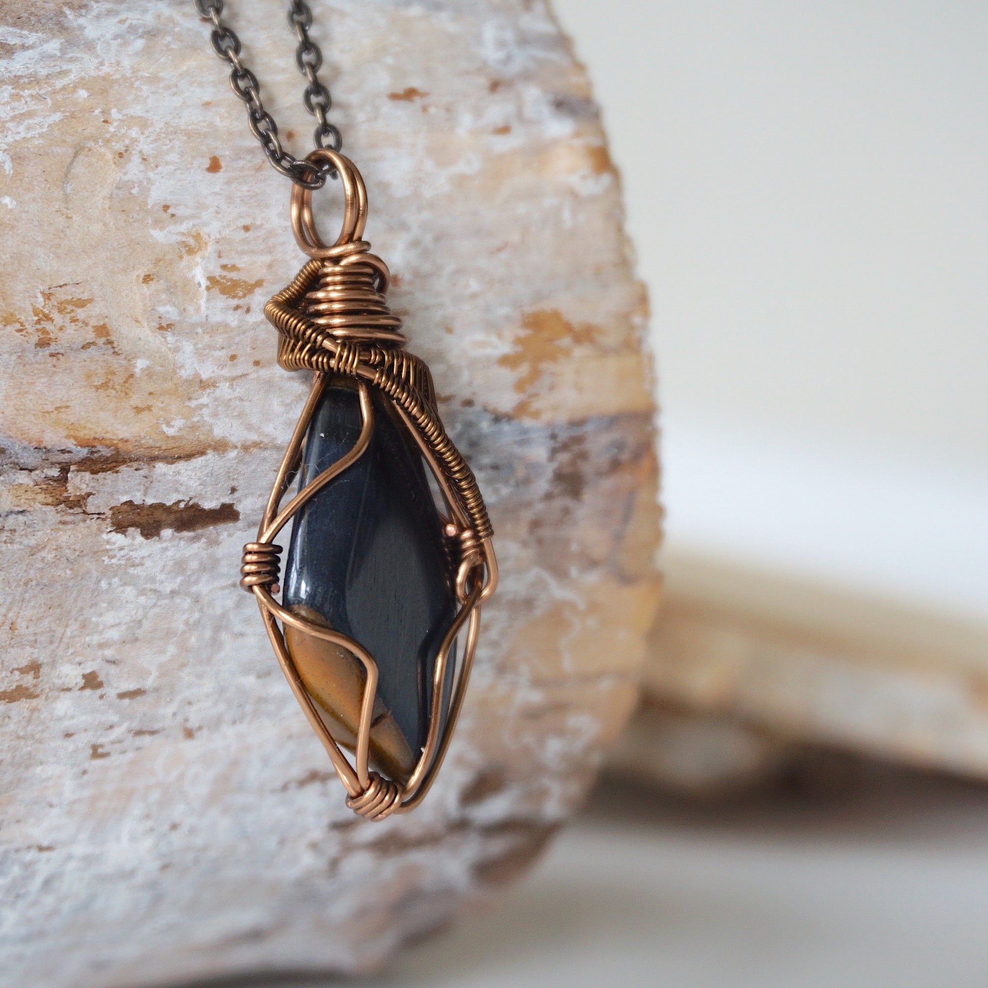 Right angle close-up of blue tiger's eye necklace for men – detailed antique bronze copper wire wrapping, natural crystal.