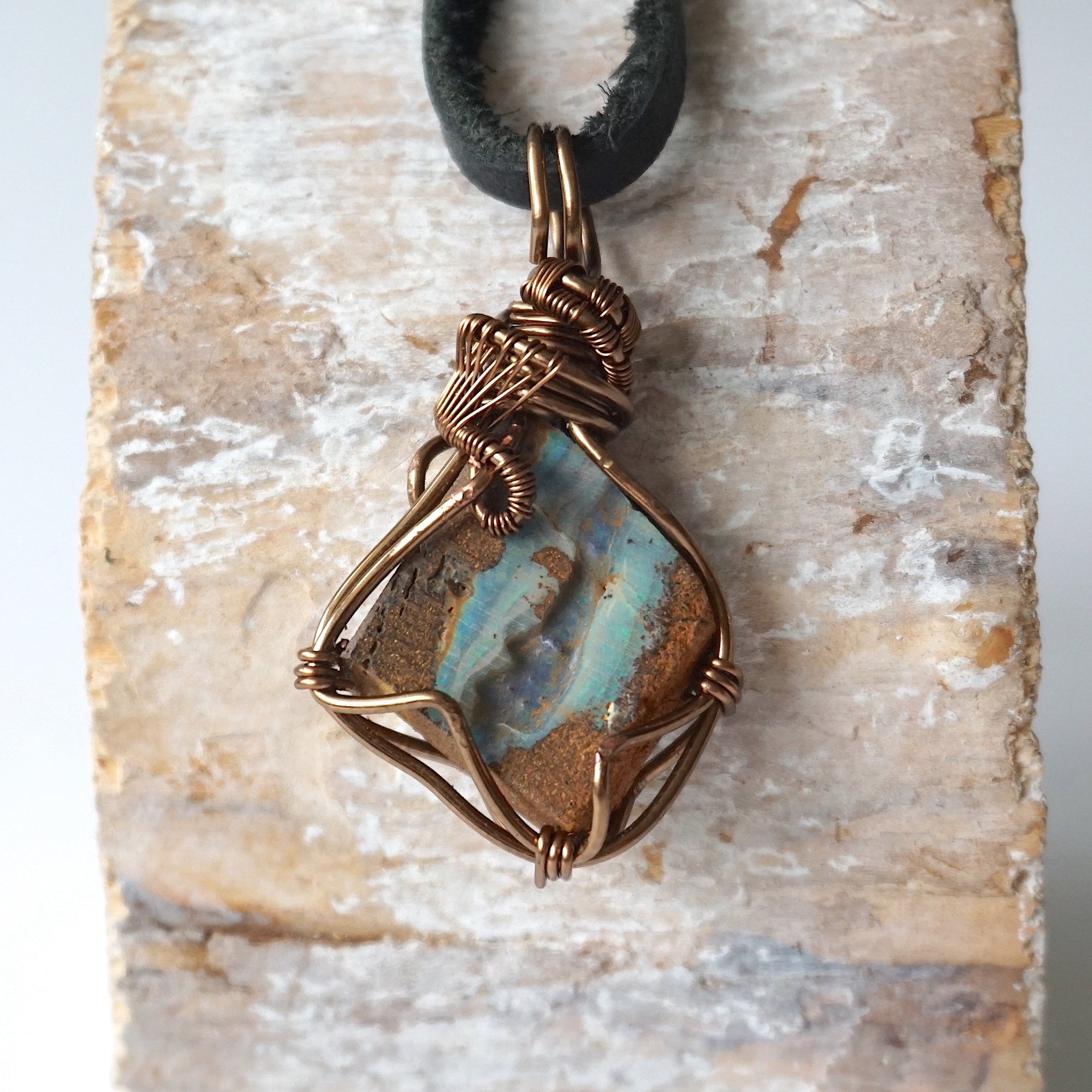 Handcrafted Australian boulder opal necklace for men, front view on black leather cord – artisan antique bronze copper wire wrapping, natural crystal pendant.