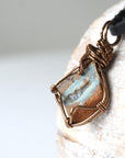 Left angle detail of Australian boulder opal necklace for men – highlights artisan bronze copper wire wrapping and natural stone colors.