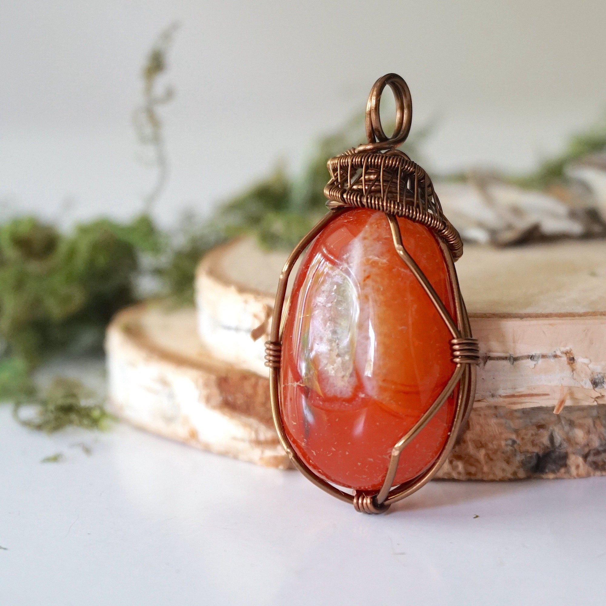 Left angle close-up of carnelian necklace – artisan wire wrapping, natural orange stone, Virgo birthstone pendant by Designs by Nature Gems.