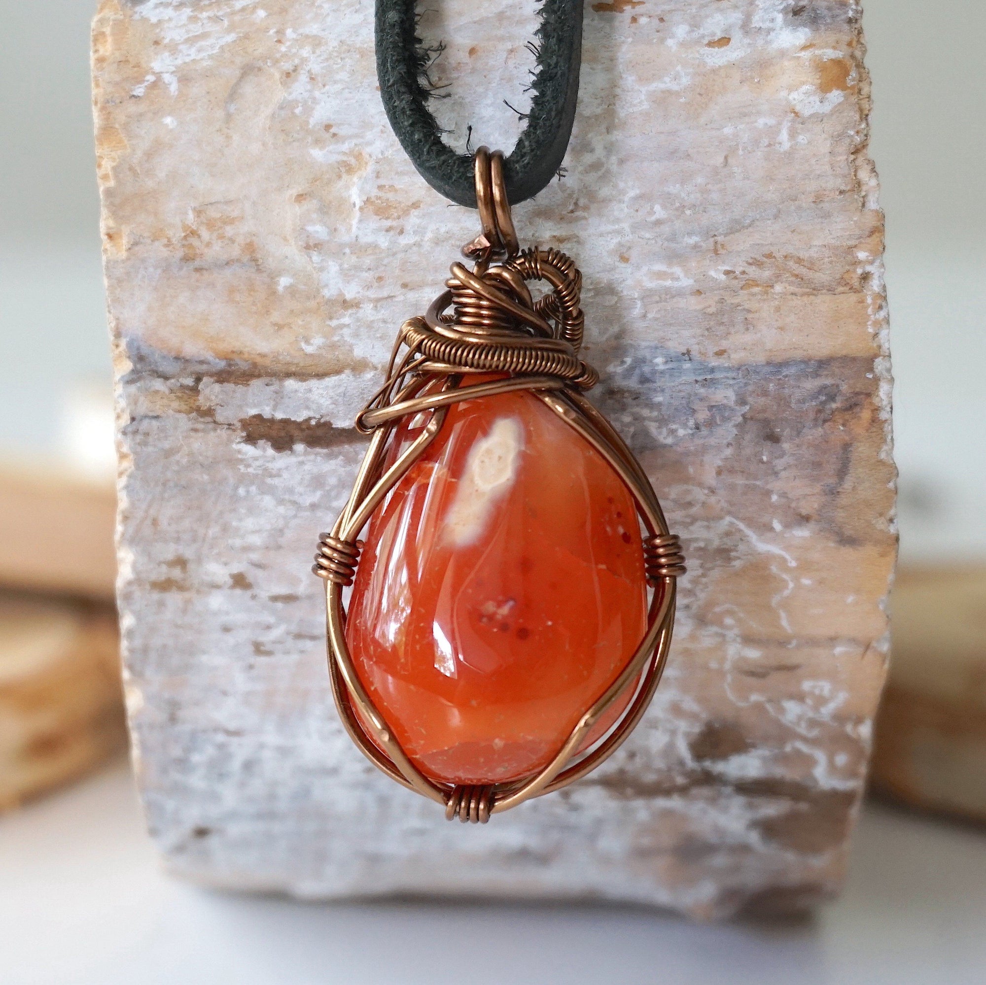 Back view of handcrafted men's carnelian necklace – natural stone and wire wrapping, Virgo birthstone, black leather cord.