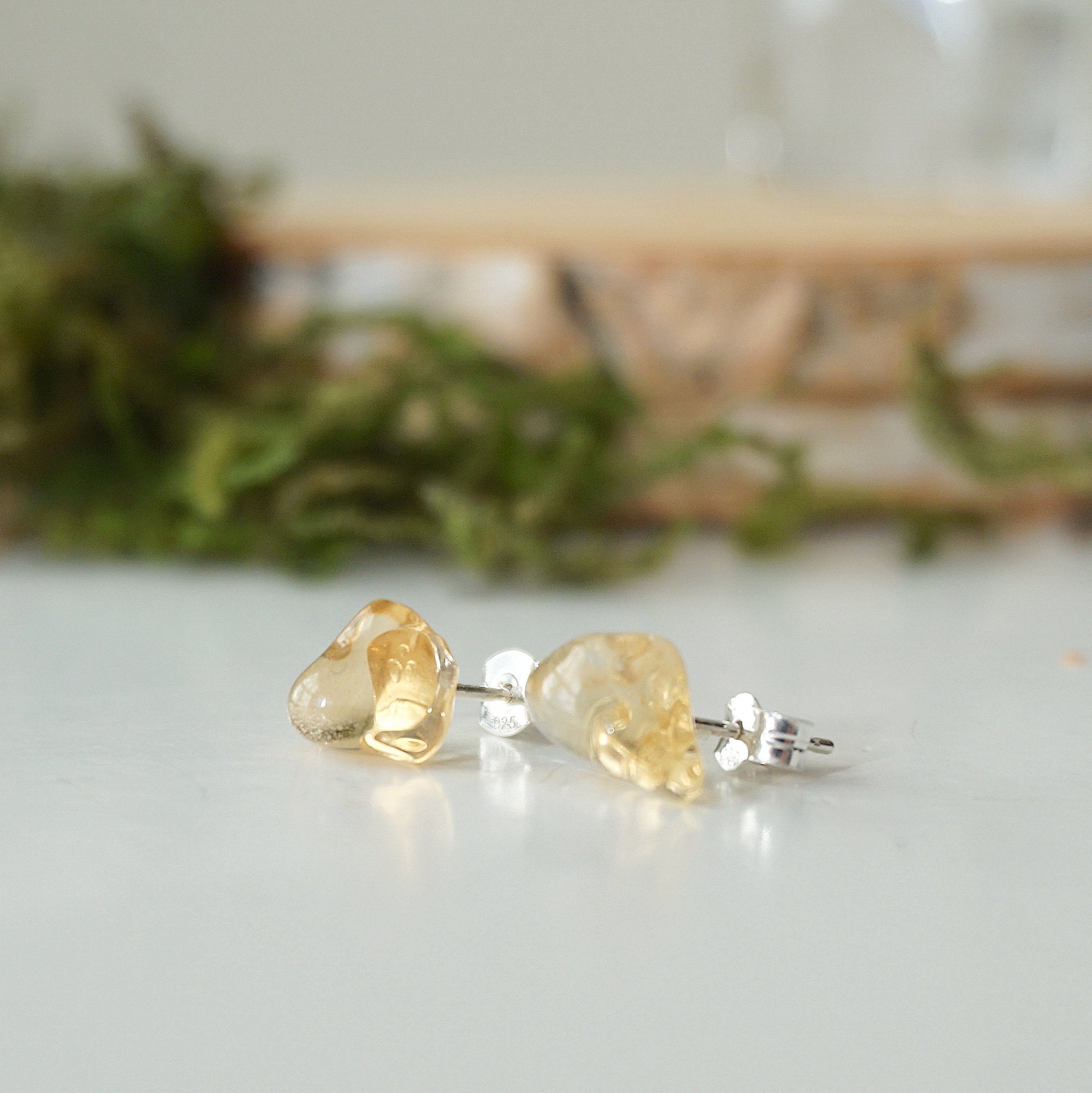 Raw citrine stud earrings on sterling silver posts shown at angle - handmade natural crystal jewelry by Designs by Nature Gems