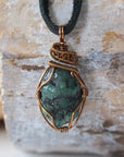 Handcrafted raw emerald necklace for men, front view – artisan bronze and silver copper wire wrapping, May birthstone, black leather cord.