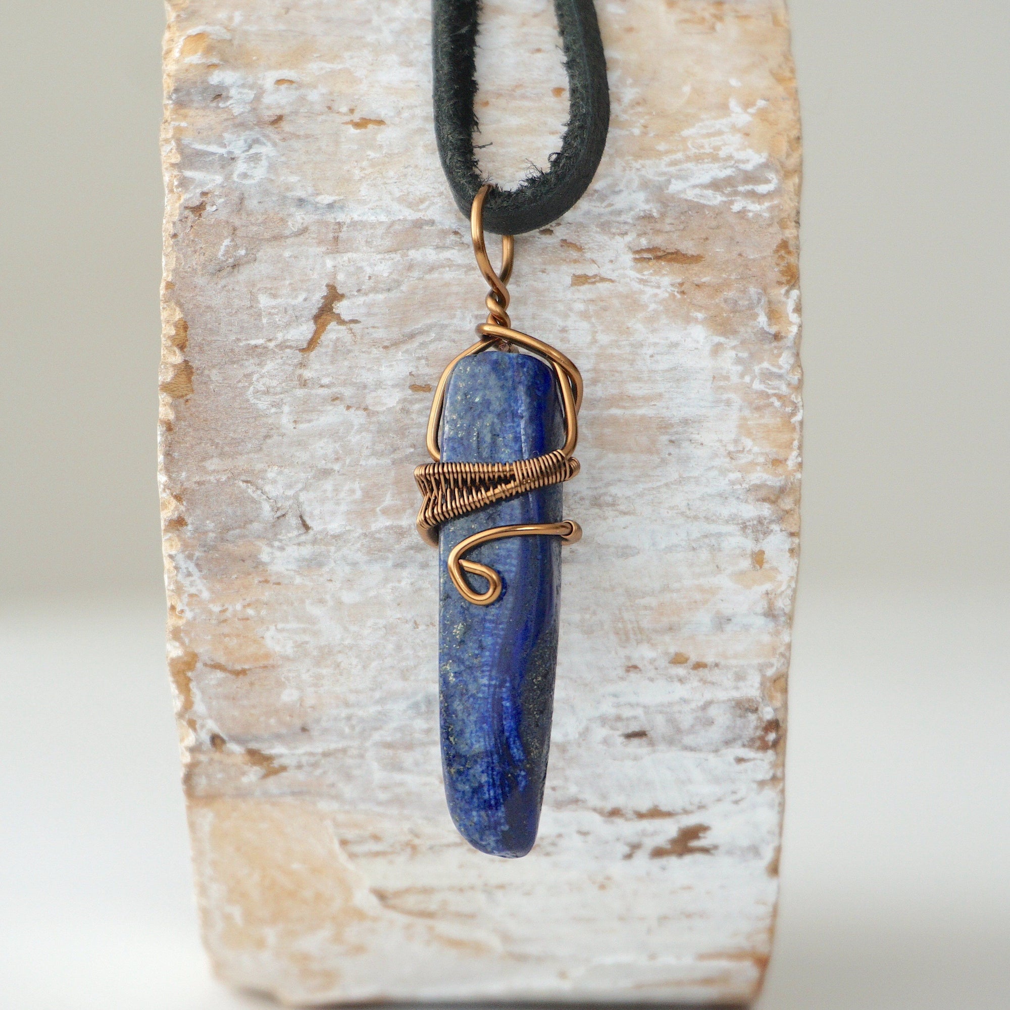 Back view of handcrafted lapis lazuli point necklace for men – natural stone and wire wrapping, alternative September birthstone, antique bronze copper.