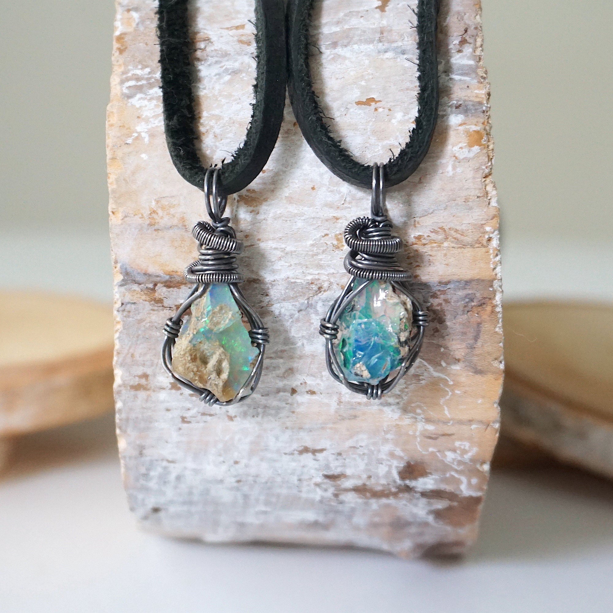 Two raw opal pendants for men – unique differences in Ethiopian fire opal crystals, wire-wrapped, black leather cord.