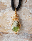 Handcrafted raw peridot necklace for men, front view – artisan warm gold copper wire wrapping, natural August birthstone pendant.