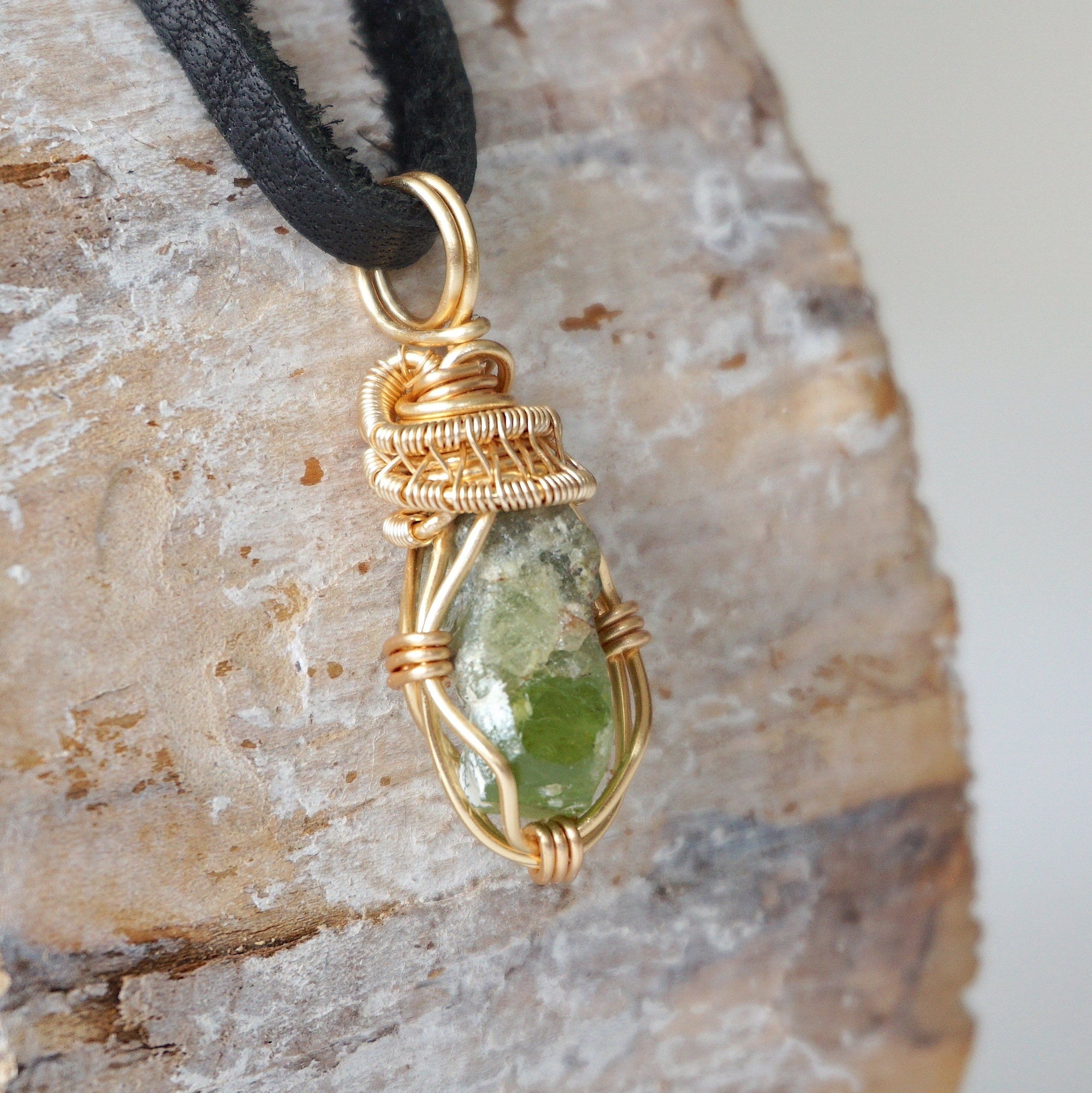 Right angle detail of raw peridot necklace for men – highlights artisan gold copper wire wrapping and organic stone texture.