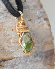 Right angle detail of raw peridot necklace for men – highlights artisan gold copper wire wrapping and organic stone texture.