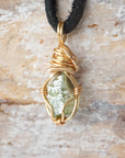 Back angle view of raw peridot necklace for men – showcases wire wrapping and natural stone matrix.