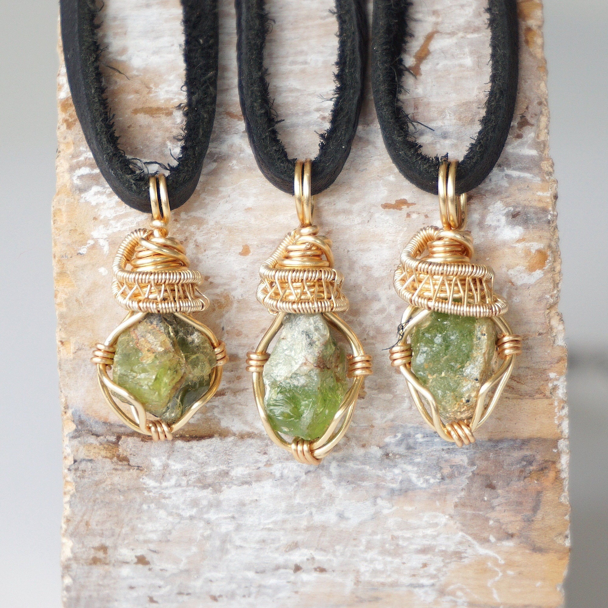 Three raw peridot necklaces for men – shows natural variation in size, shape, and green color of peridot stones.