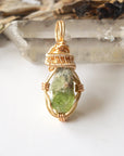 Handcrafted raw peridot necklace for women, front view – artisan warm gold copper wire wrapping, lively green stone.