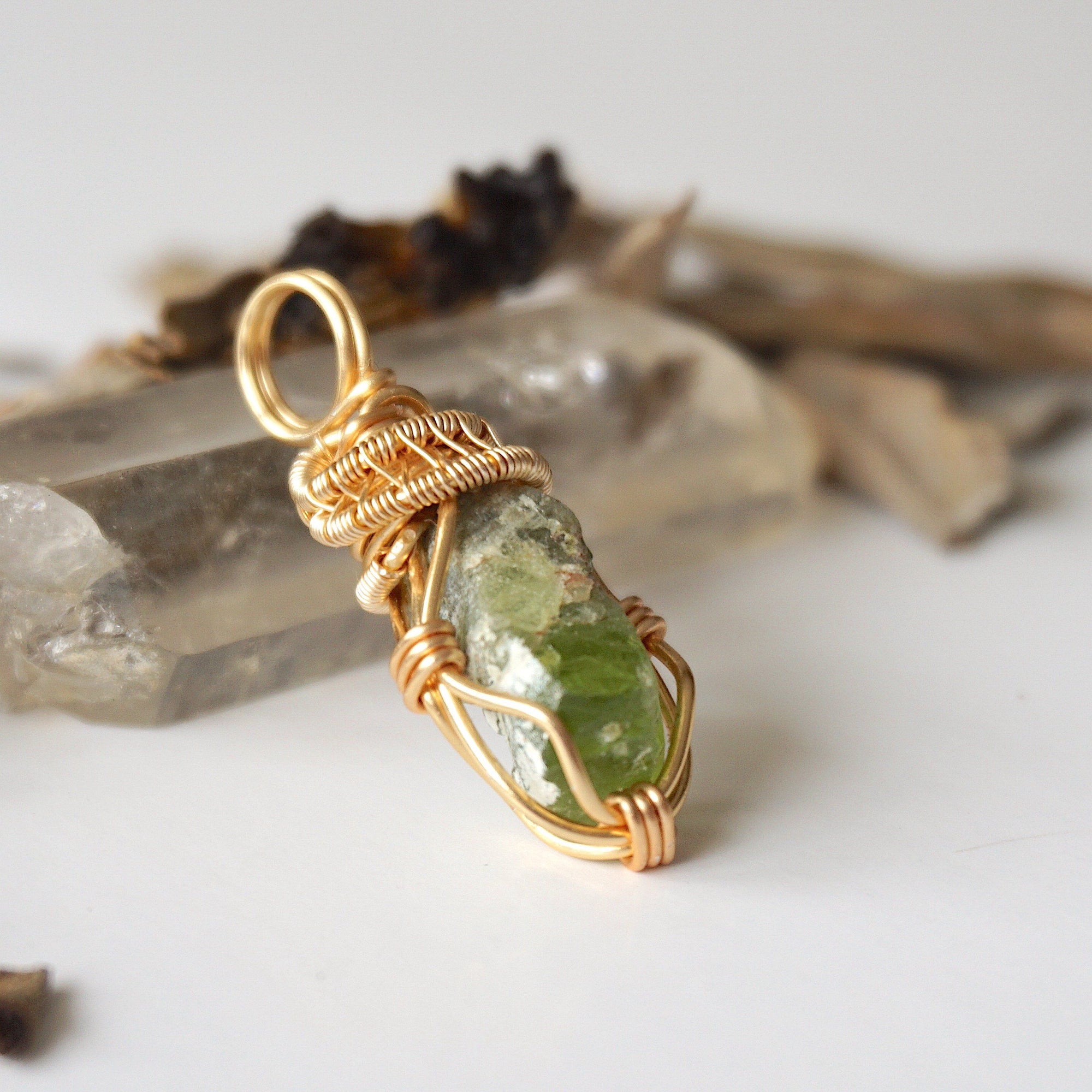 Right angle detail of raw peridot necklace for women – highlights artisan gold copper wire wrapping and organic stone texture.