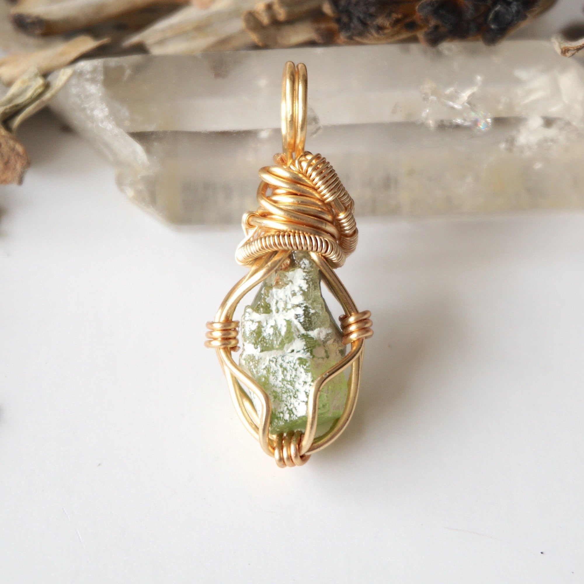 Back angle view of raw peridot necklace for women – showcases wire wrapping and natural stone matrix.