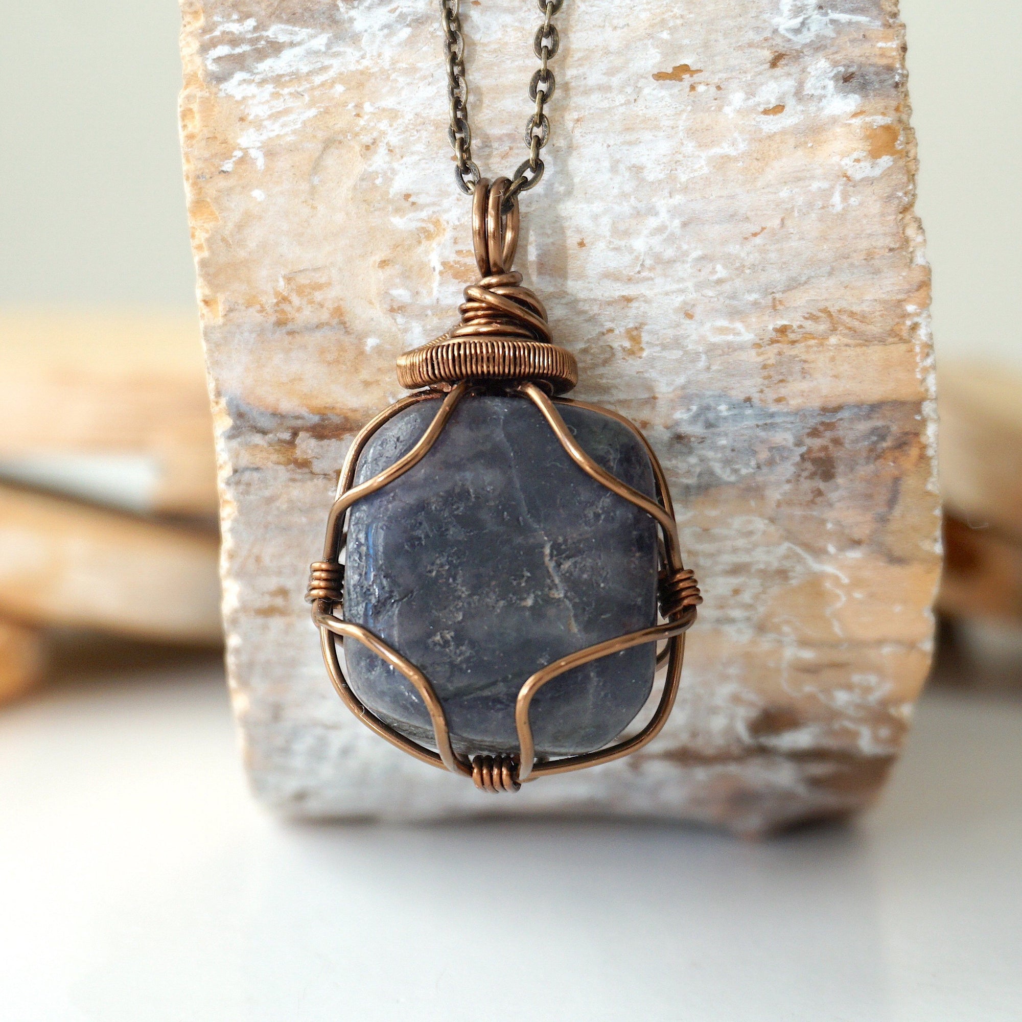 Handcrafted raw sapphire necklace, front view – artisan bronze copper wire wrapping, September birthstone jewelry for all genders, Designs by Nature Gems.