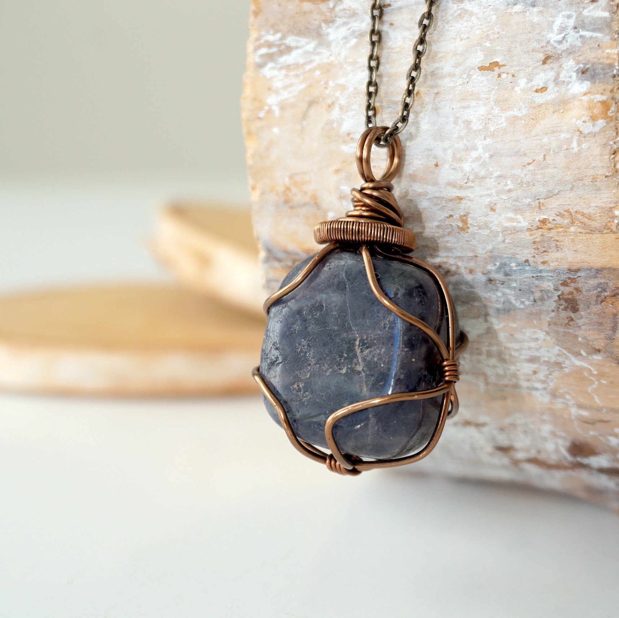 Left angle close-up of sapphire necklace – highlighting unique wire-wrapped artistry, genuine sapphire, gender-inclusive jewelry.