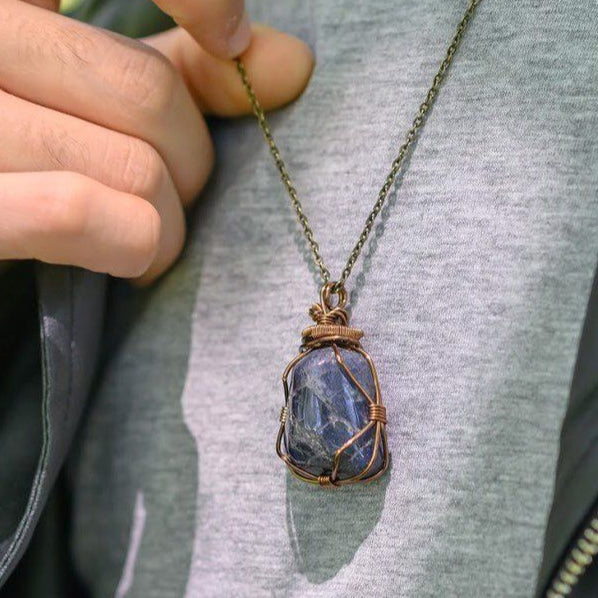 Sapphire necklace worn by male model – genuine raw sapphire pendant, bronze copper wire, unisex September birthstone jewelry.