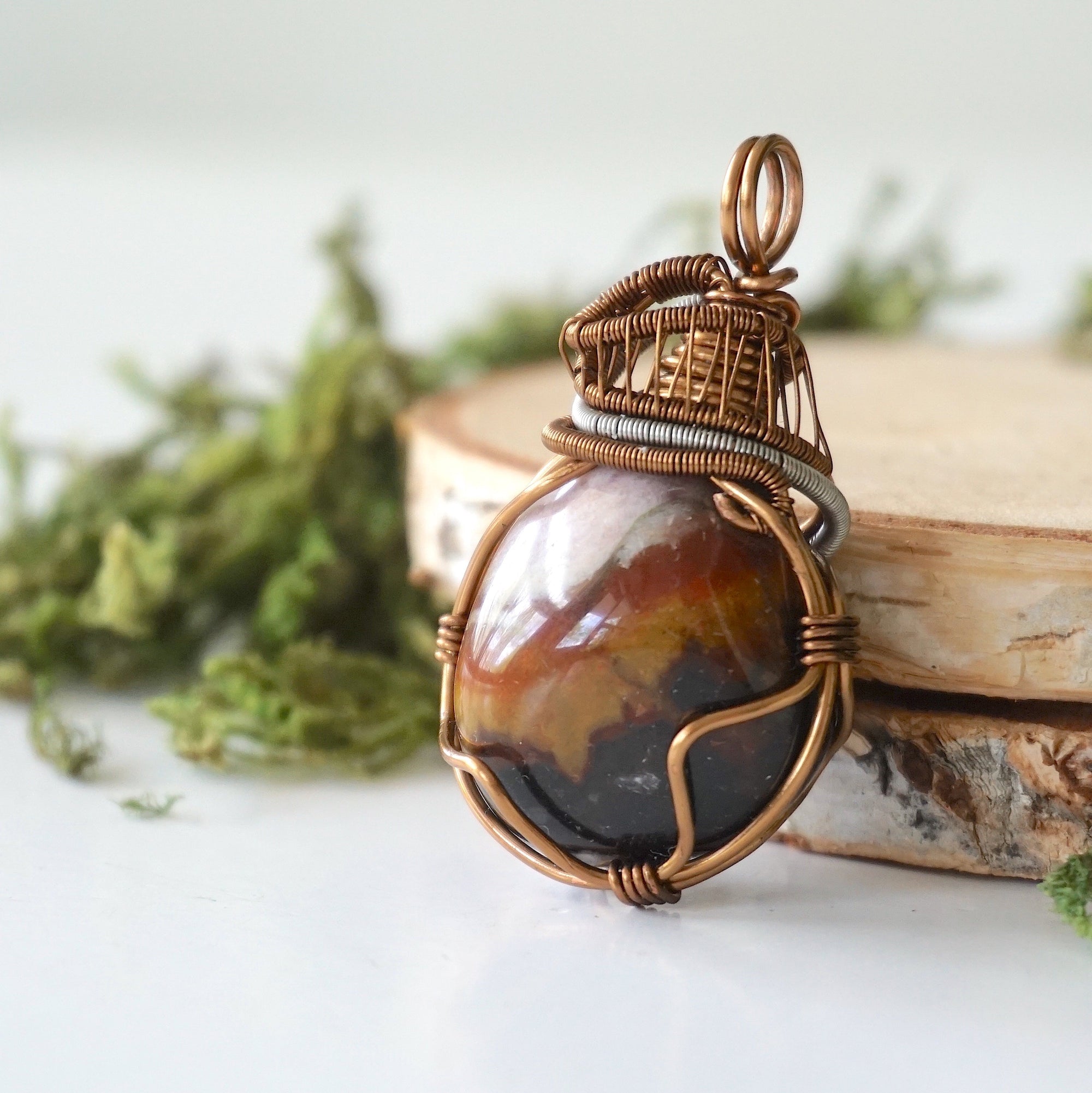 Left angle close-up of sardonyx necklace – artisan wire wrapping, banded natural stone, August birthstone pendant by Designs by Nature Gems.