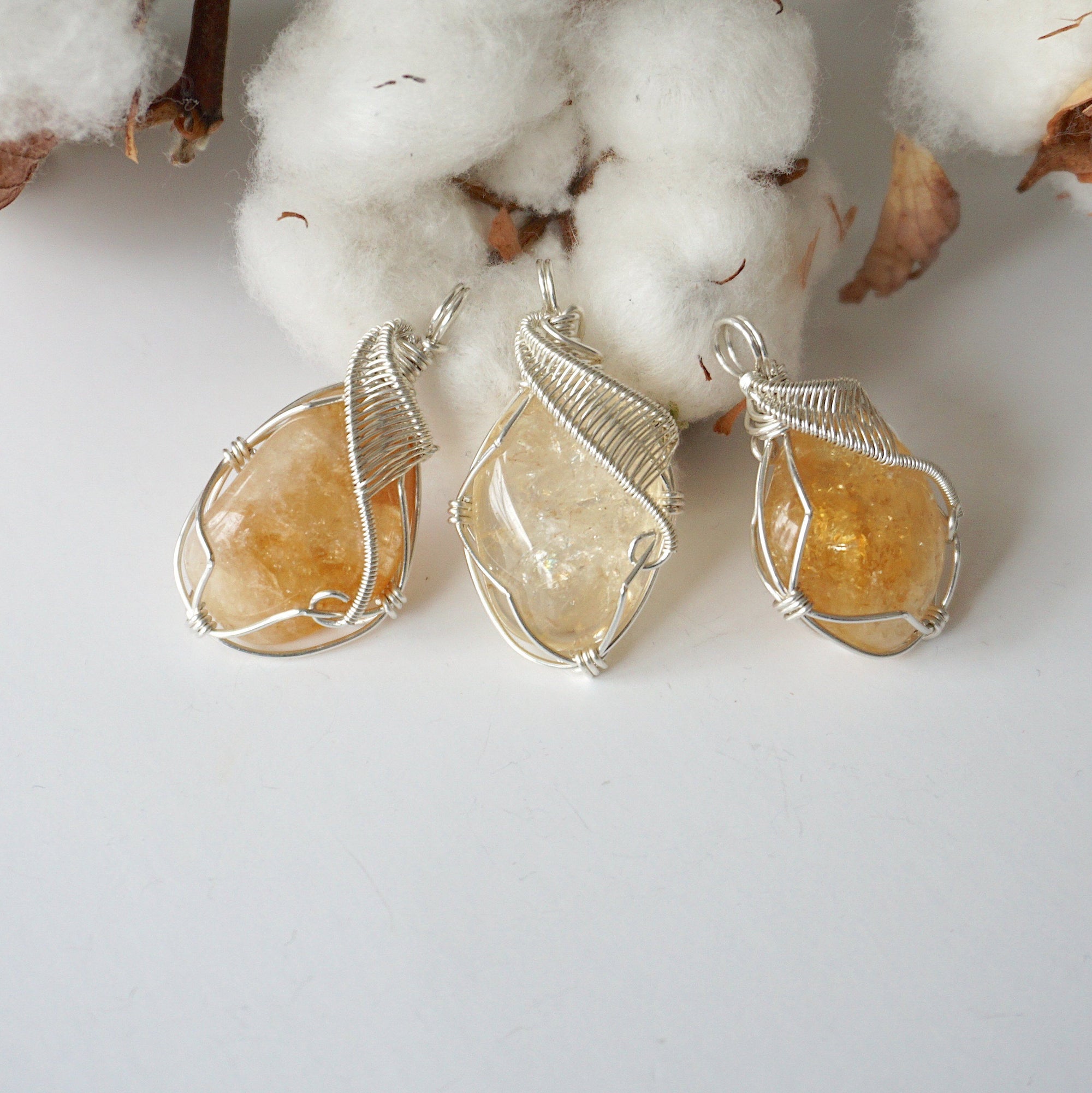 Three wire wrapped citrine necklaces showing natural stone color variation from honey to amber and size options

