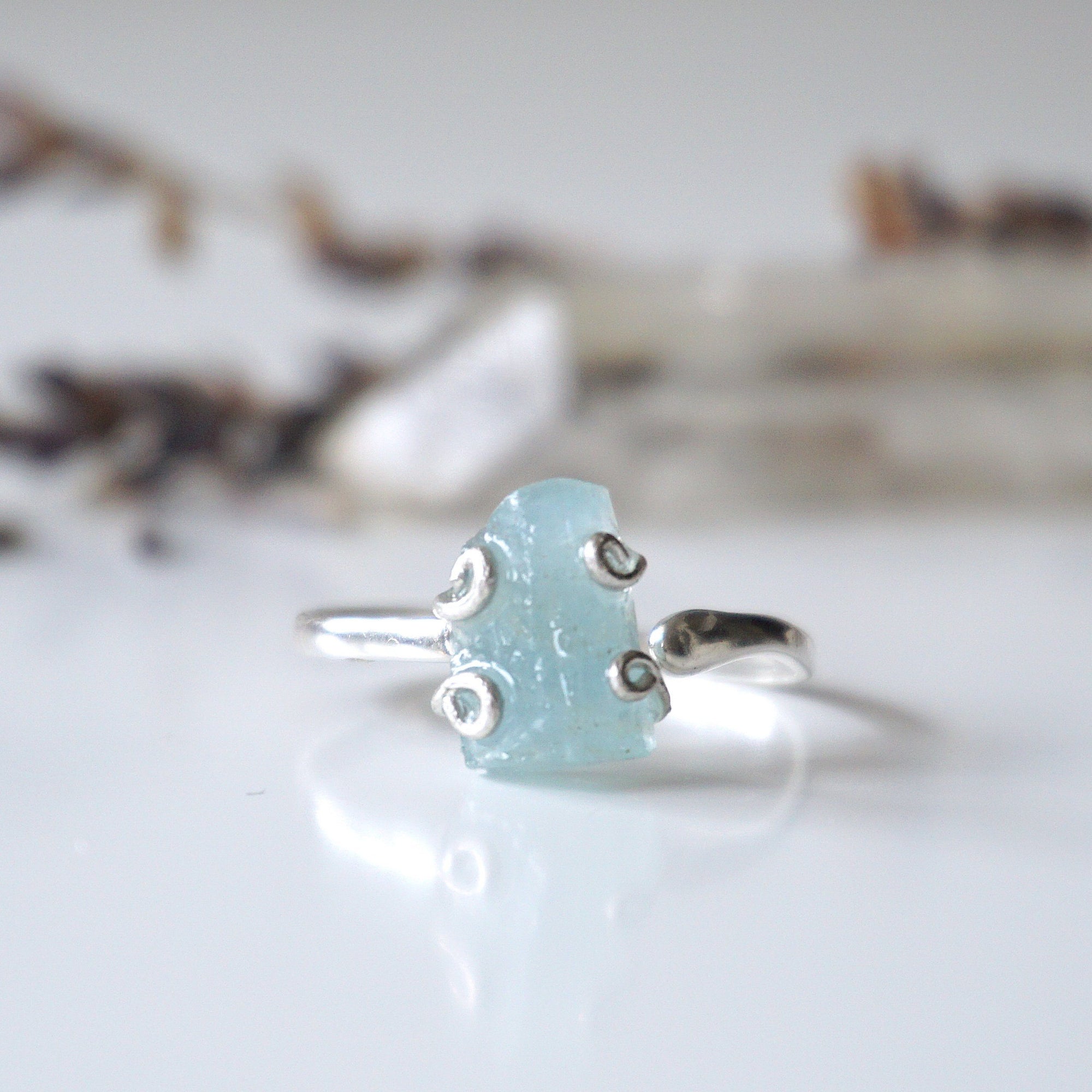 Detailed front angle of adjustable aquamarine ring, raw aquamarine, 925 sterling silver prong setting