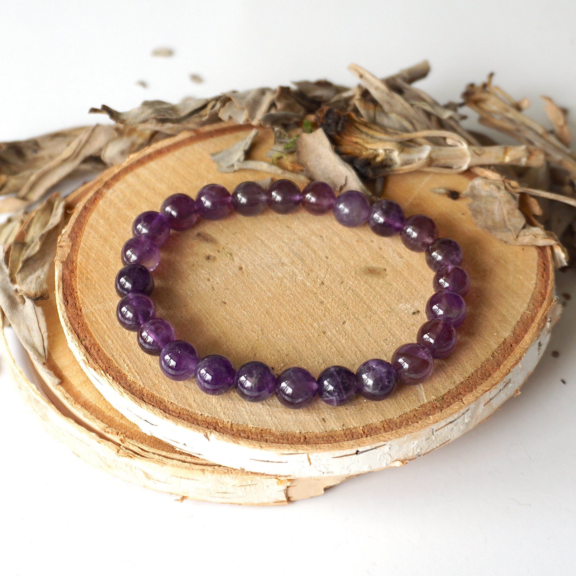 Top view of amethyst beaded stretch bracelet, natural 8mm amethyst beads, unisex design