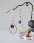 Front view of amethyst drop earrings with 8mm polished amethyst bead in silver plated copper wire wrapped teardrop dangle design