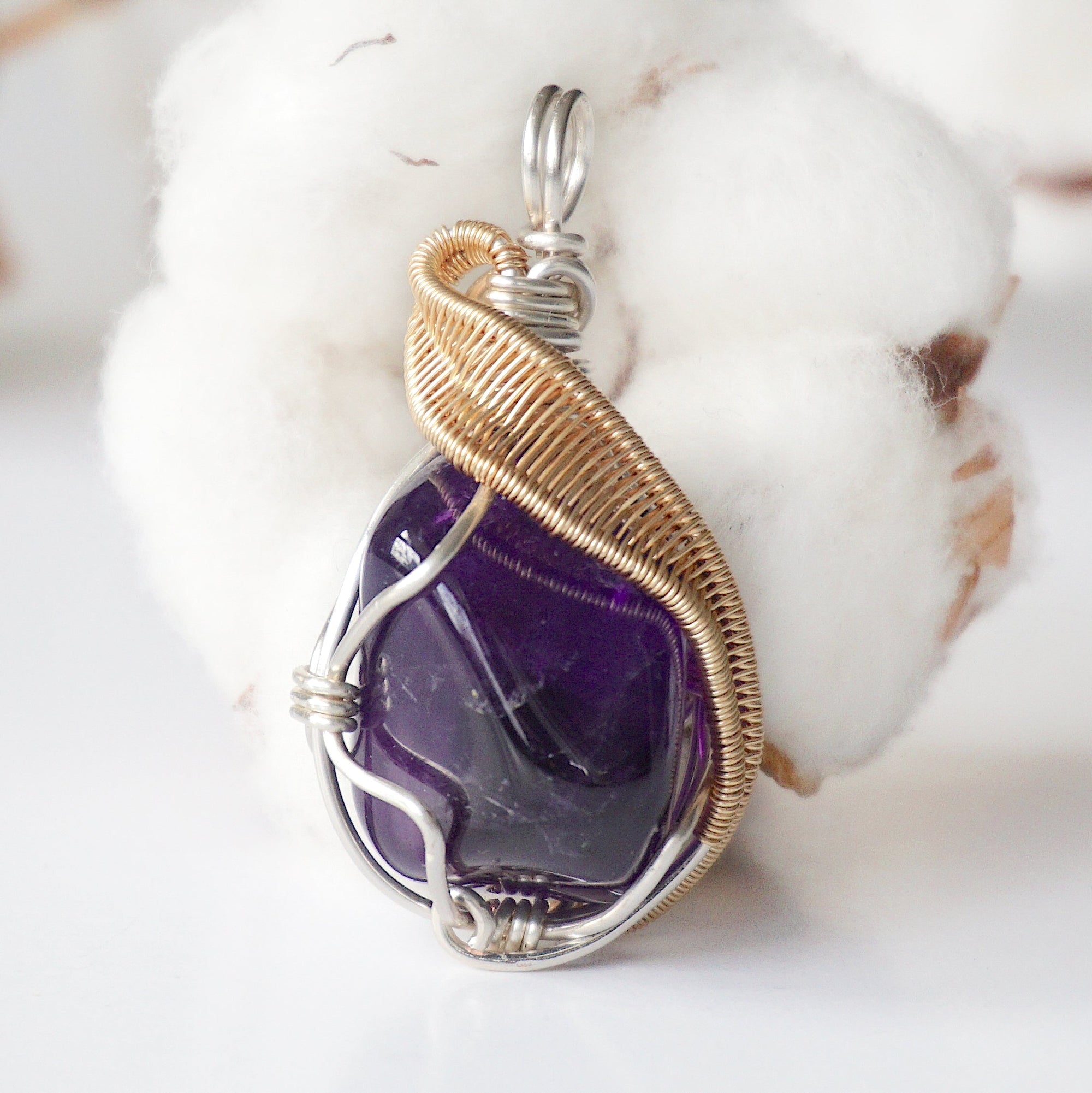 Front side angle of women’s amethyst necklace, polished dark amethyst, silver and gold plated copper wire wrap