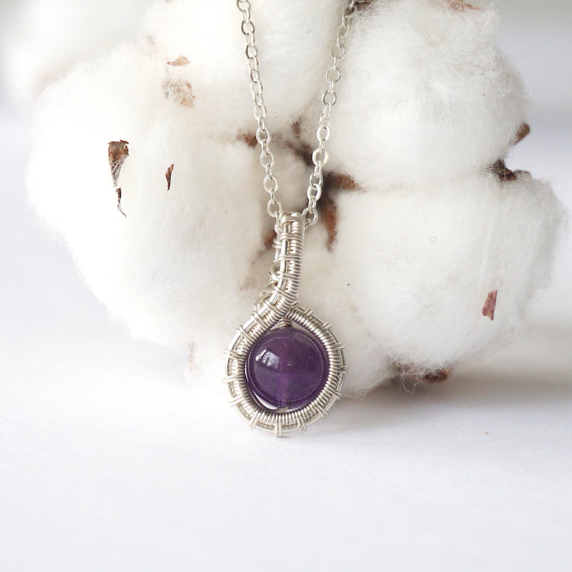 Detailed front view of women’s amethyst necklace, 8mm amethyst bead, artisan wire wrapped in silver plated copper