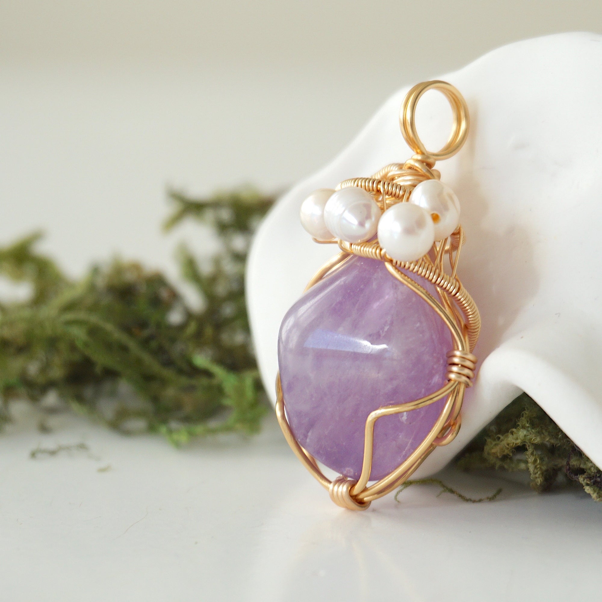 Side angle detail of amethyst and freshwater pearl pendant, gold wire wrapped, ethical artisan necklace