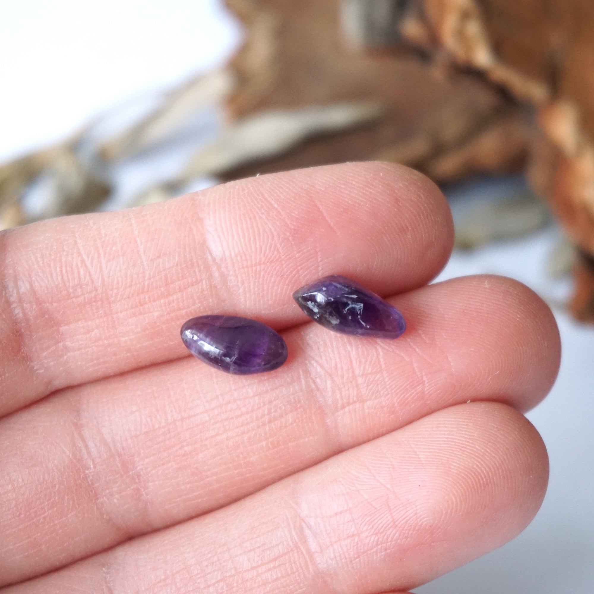 Amethyst stud earrings in hand for size reference, natural dark amethyst, sterling silver posts