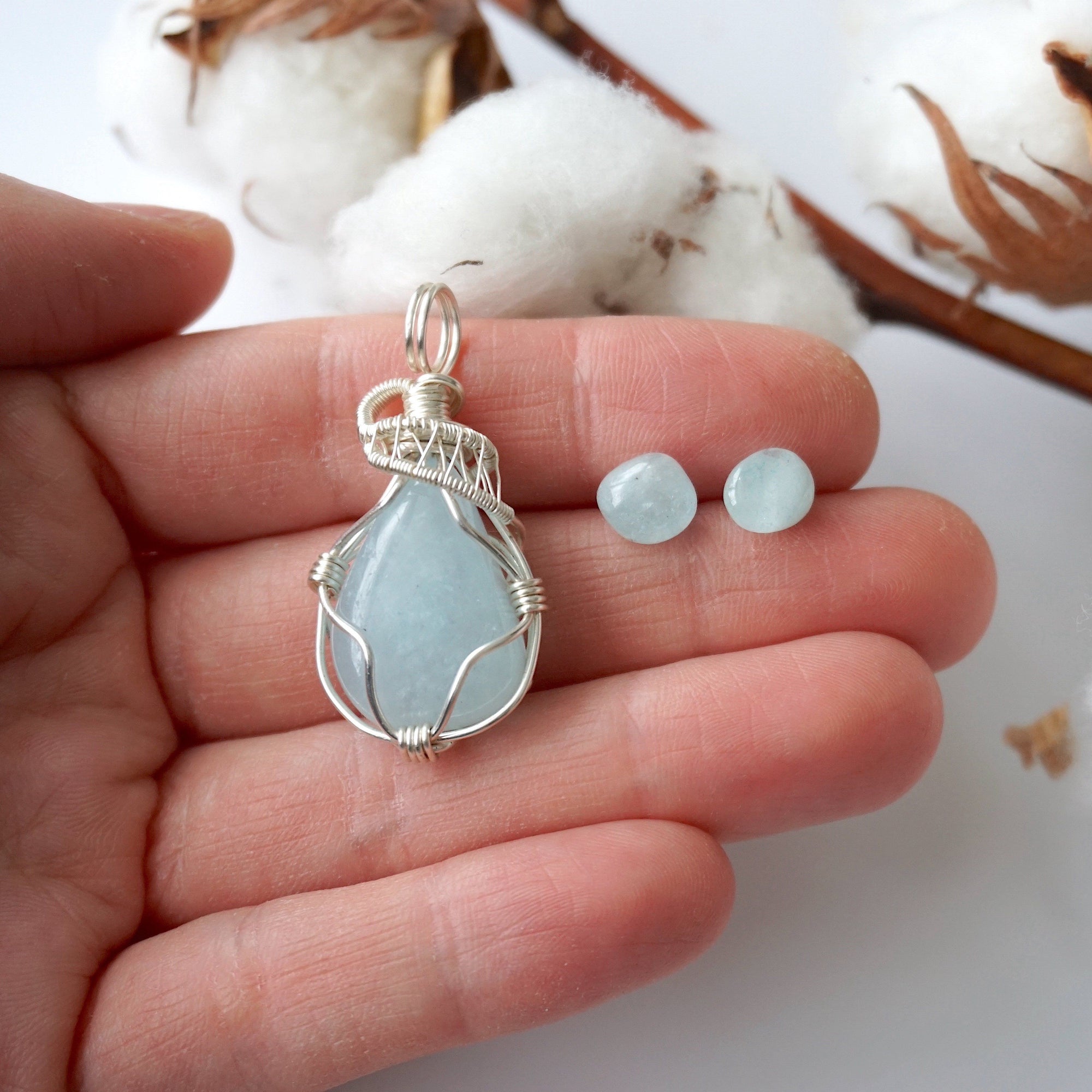 Aquamarine jewelry set with artisan wire wrapped necklace and stud earrings in a hand for size reference, genuine aquamarine, Designs by Nature Gems