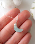 Aquamarine moon necklace in hand for size reference, genuine faceted moon, sterling silver wire wrapping
