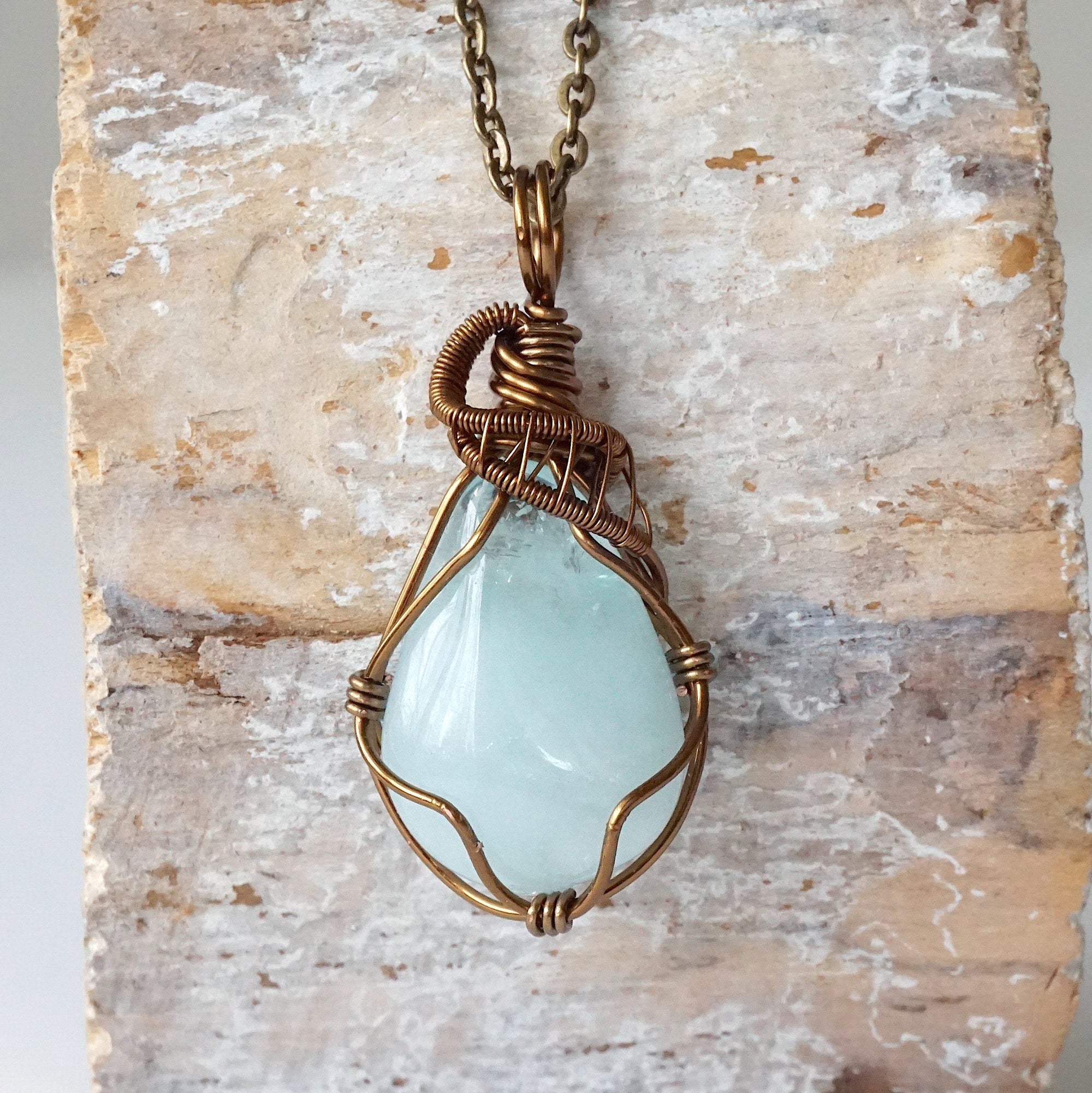 Detailed front view of genuine aquamarine necklace, artisan wire wrapped in antique bronze copper by Designs by Nature Gems.
