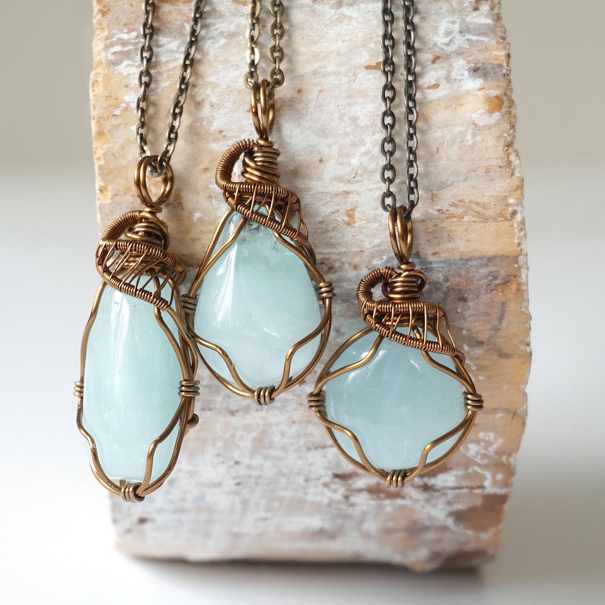 Three genuine aquamarine necklaces showing natural variation in stone size, color, and shape, artisan jewelry by Designs by Nature Gems.