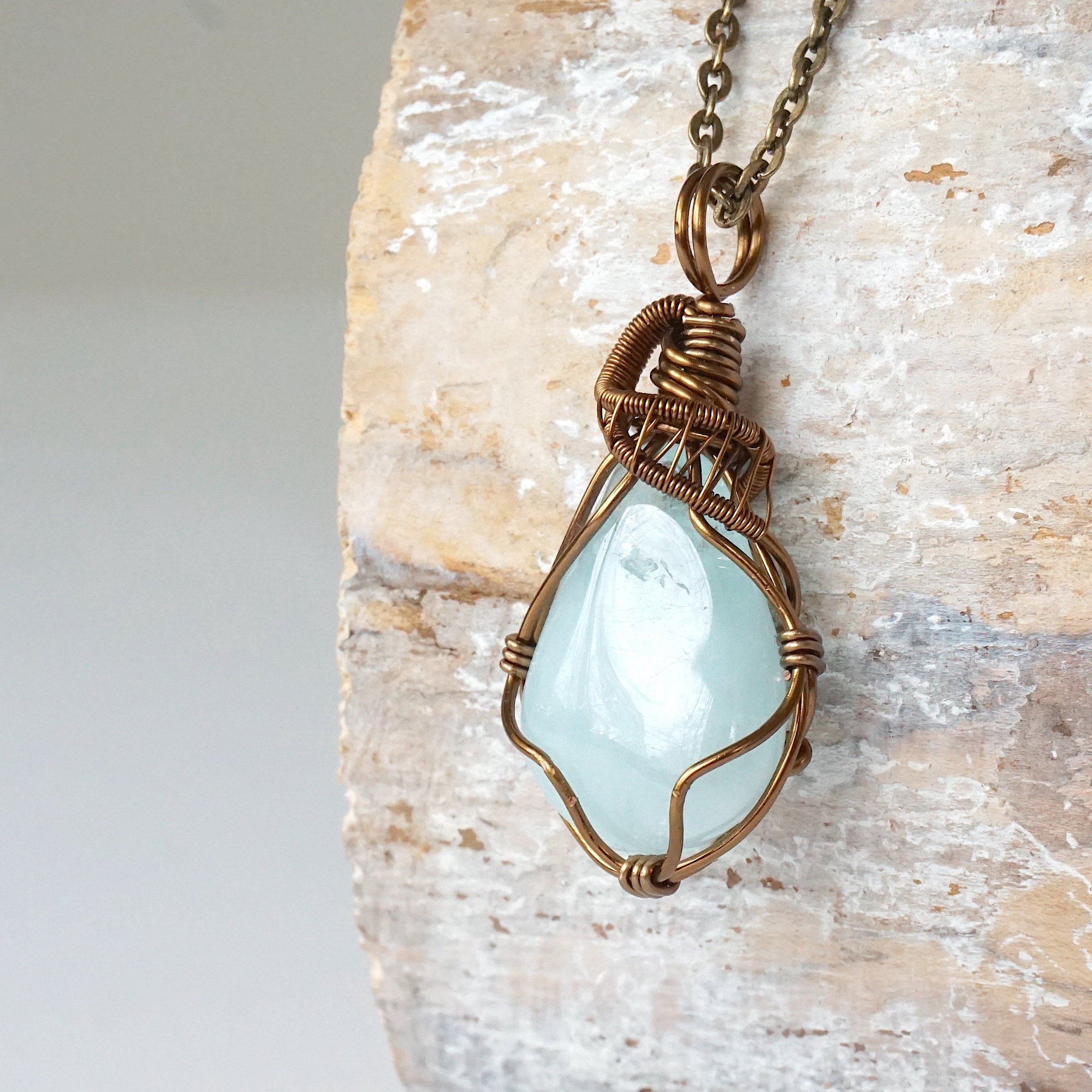 Left angle detail of genuine aquamarine necklace, artisan wire wrapped pendant by Designs by Nature Gems.